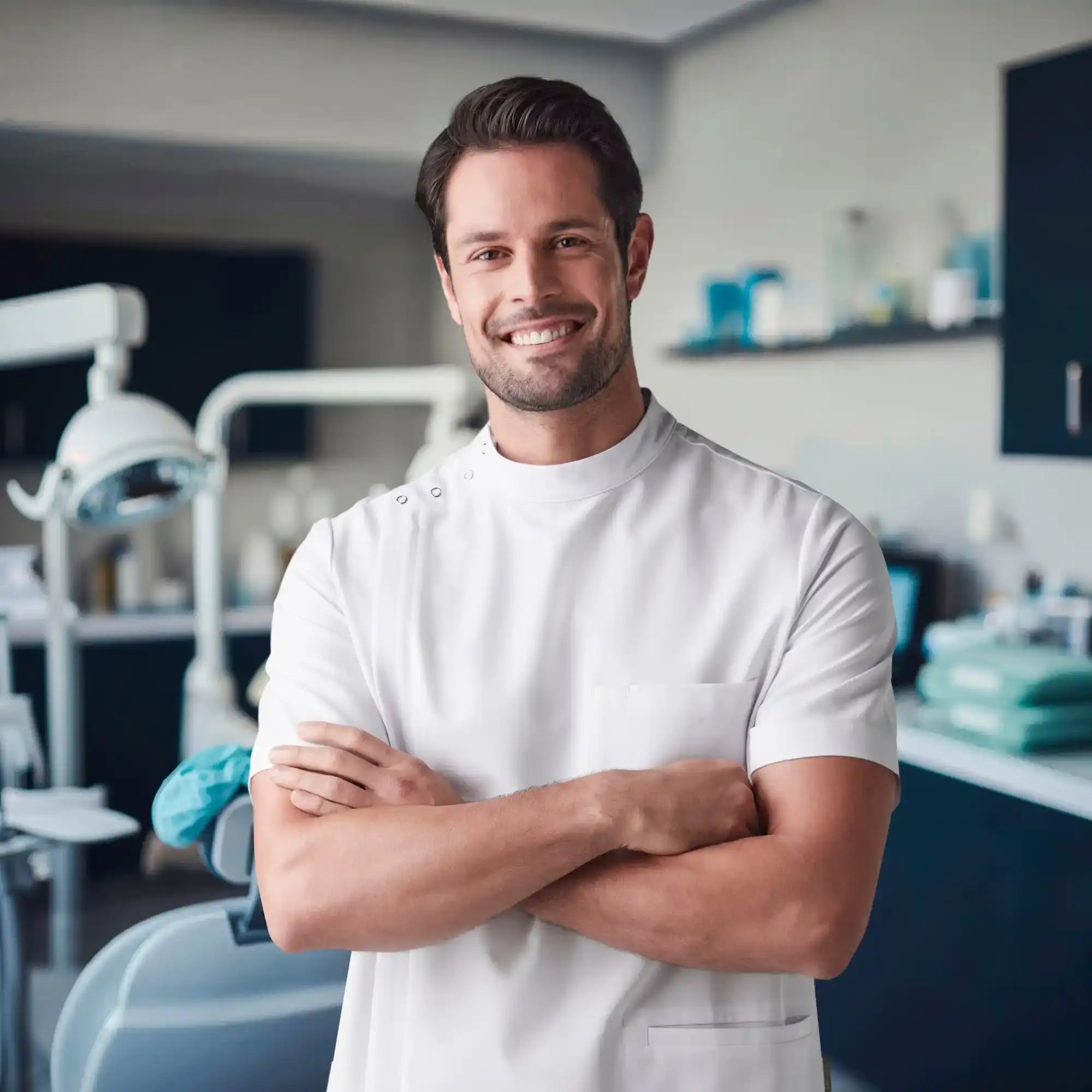 Smiling dentist with crossed arms.