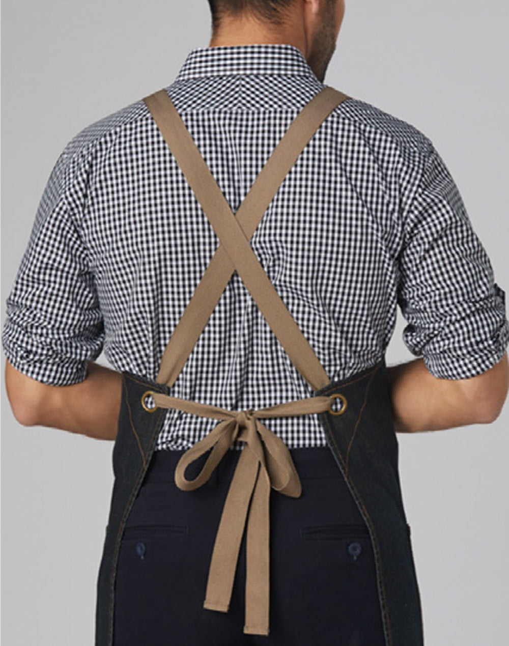 Back view of East Village Denim Bib Apron in tan cross-back cotton denim