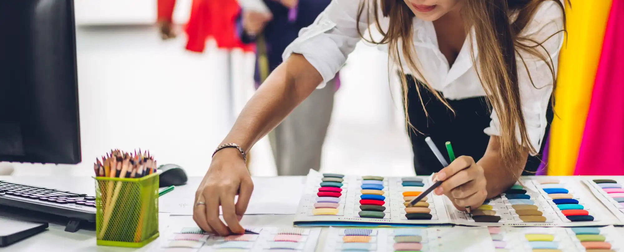 Fashion designer selecting fabric swatches.