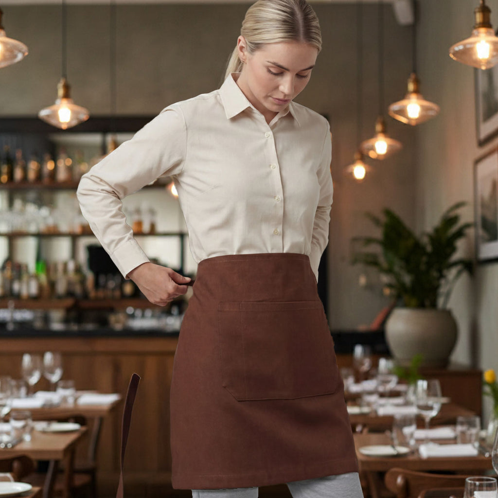 Fitzroy half waist apron in brown with front pocket on server
