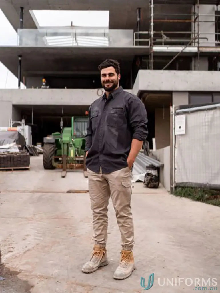 Man in Flx & Move Utility Work Shirt with active fit and beige work pants