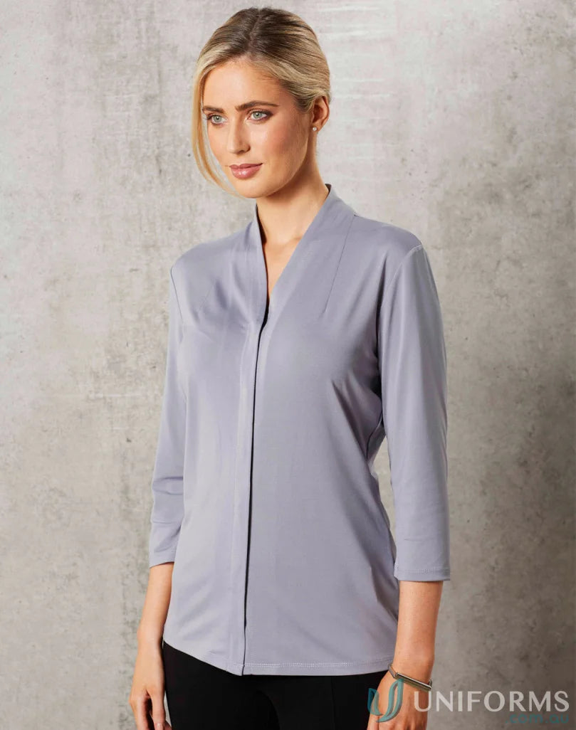 Lady wearing Ladies Isabel Stretch Knit Top in light gray with V-neckline for a casual look