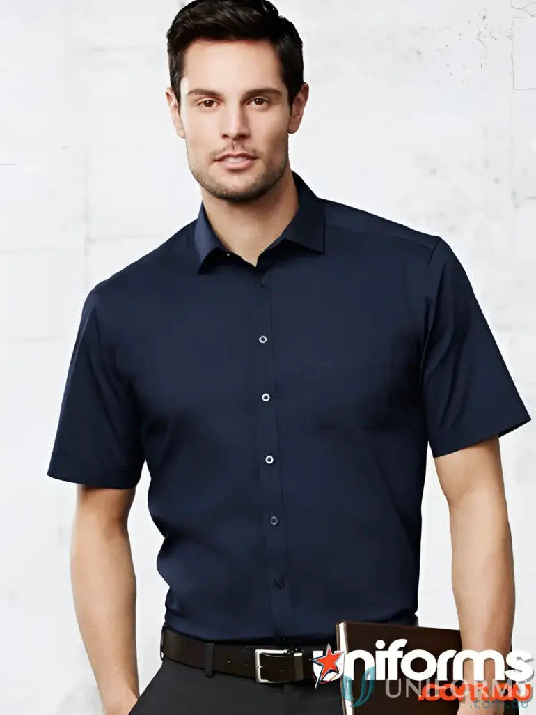 Man wearing navy blue IWG EMB Mens SS Shirt with modern narrow collar and black pants