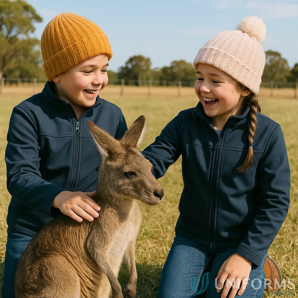 Kids in JBs Youth Layer Softshell Jacket playing with a kangaroo outdoors