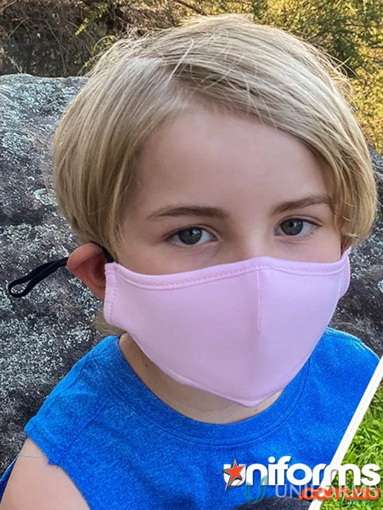 Young kid wearing a light pink cotton face mask with adjustable toggle for kids face masks