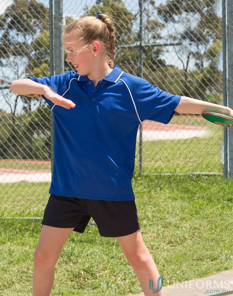 Girl throwing discus in Kids Champion Raglan SS Polo showcasing winning spirit kids