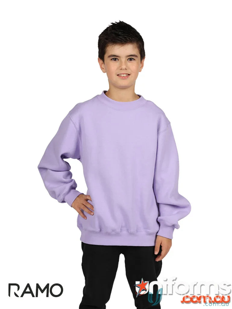 Cute kid wearing a light purple kids crew neck sloppy joe sweatshirt and black pants