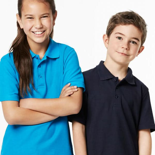 Two kids wearing stylish Kids Crew Polo shirts from Biz Collection Kids school uniform game