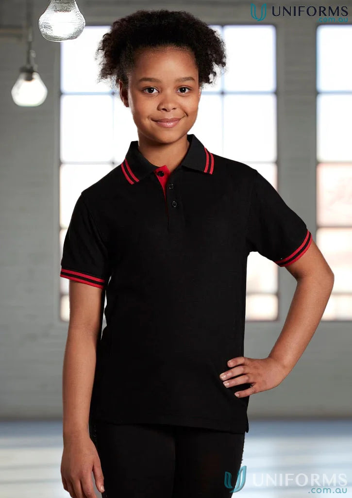 Kids Grace Polo in black with red trim, made with truedry pique short sleeve polo ps65k fabric