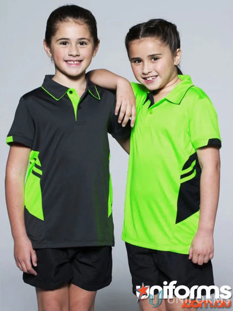 Two young girls wearing matching kids Tasman Polo shirts and shorts for a fun sporty look