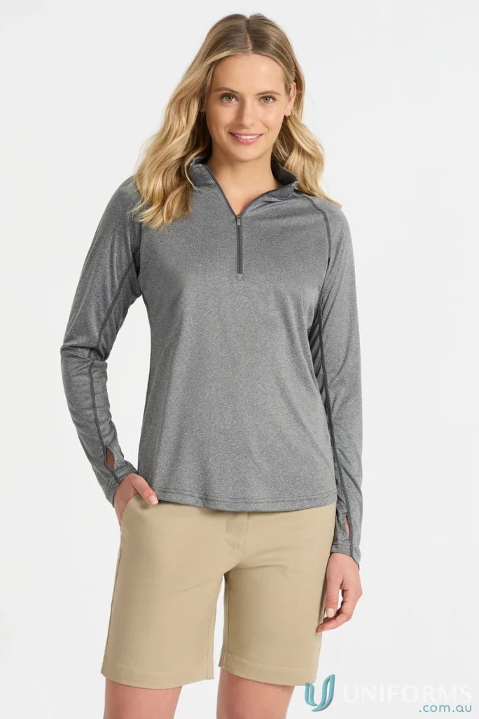 Woman wearing a gray long-sleeved shirt and khaki shorts in Ladies Apex Baselayer ensemble