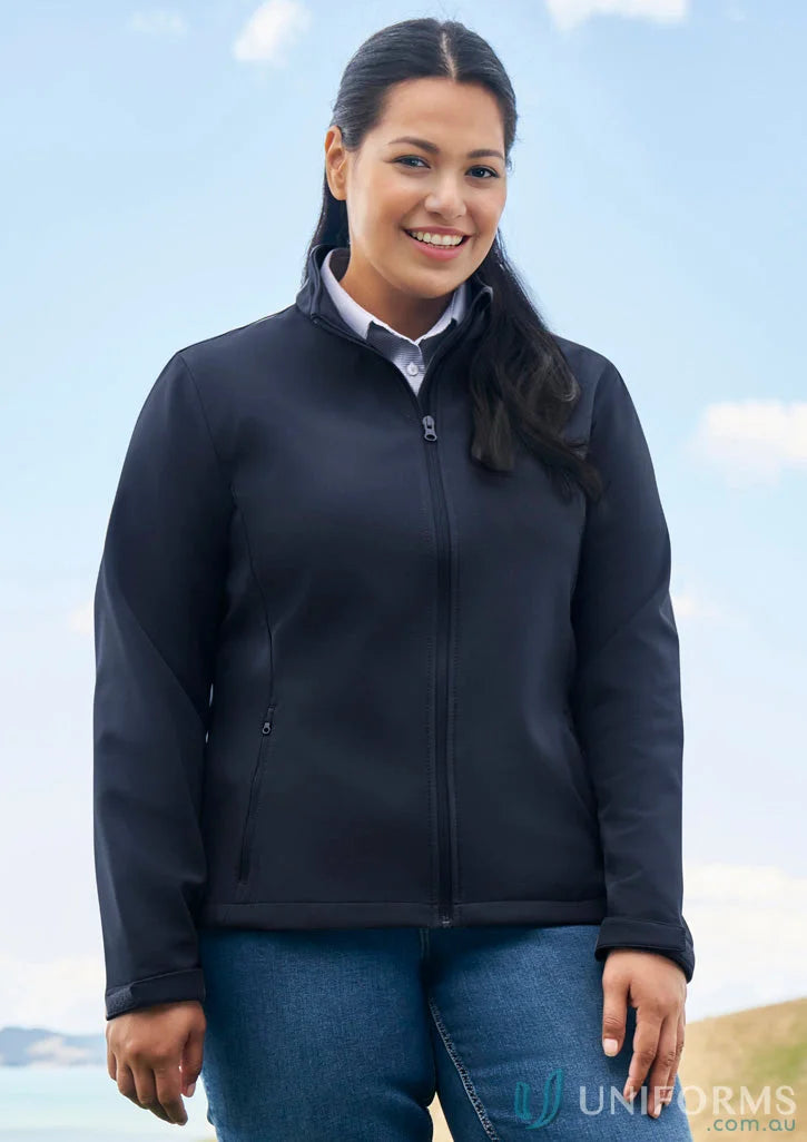 Woman in navy ladies Apex Softshell Jacket, perfect for biz collection women’s style