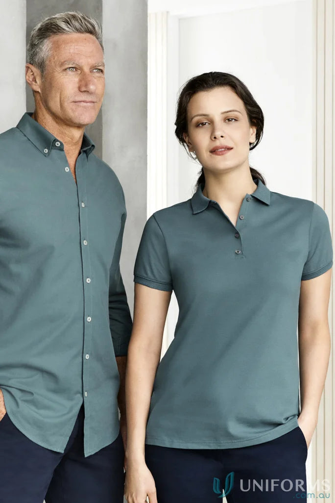 Two people modeling matching teal ladies city city polo short sleeve polo shirts