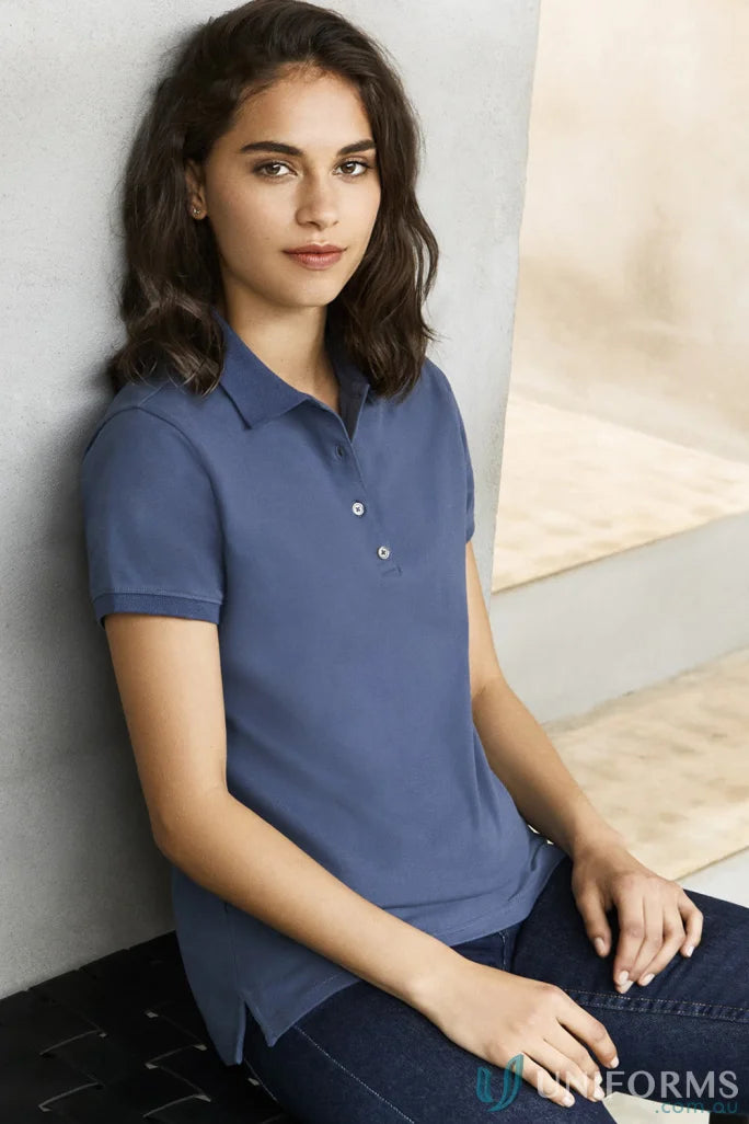 Lady modeling ladies city city polo short sleeve polo in solid blue