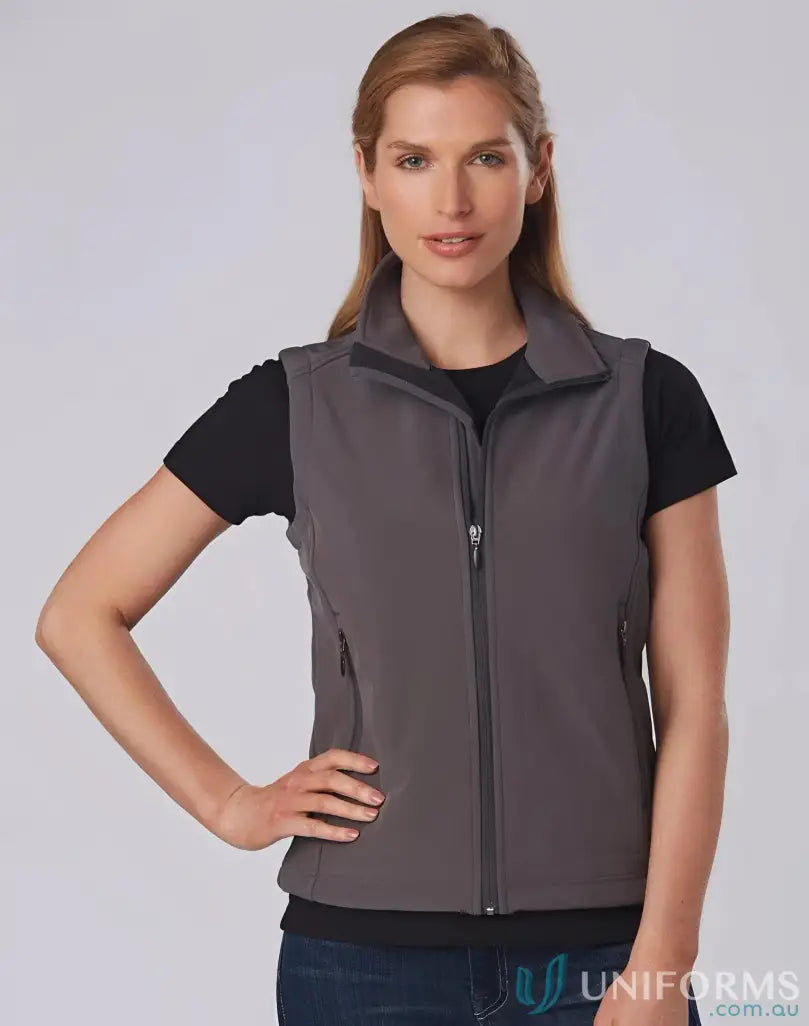 Woman wearing jk26 ladies softshell vest in softshell hi-tech vest style