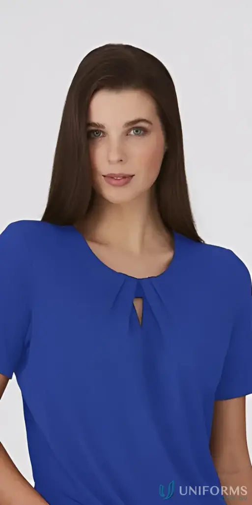 Woman in royal blue keyhole knit top with crepe texture, perfect for uniforms