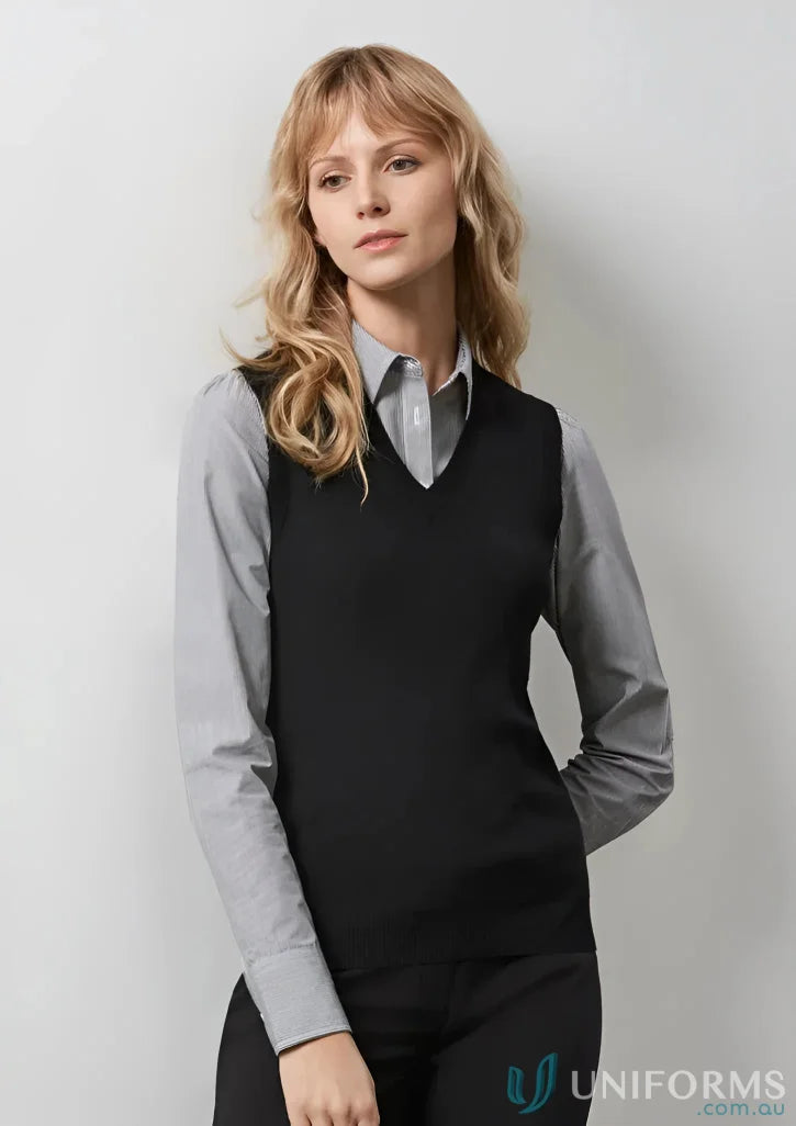 Woman wearing a black ladies knit vest with a V-neck, perfect for a stylish look