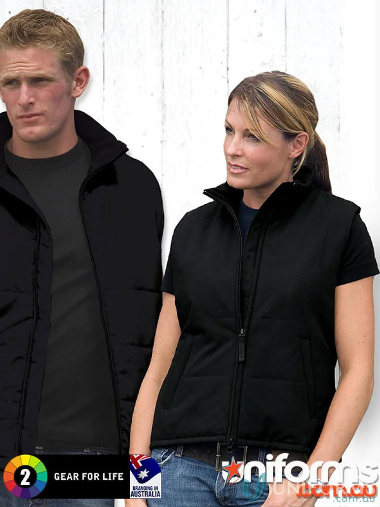 Two women wearing stylish black padded jackets and vests showcasing the Ladies Legacy Vest