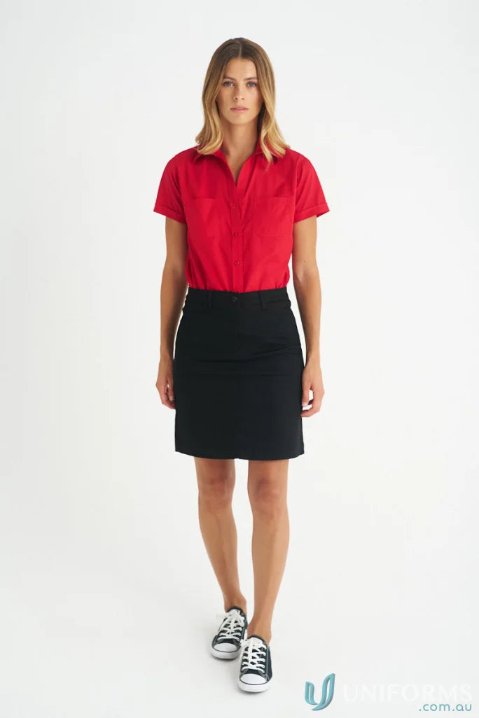 Woman wearing a red lily chino skirt with black and white sneakers for ladies lily chino style