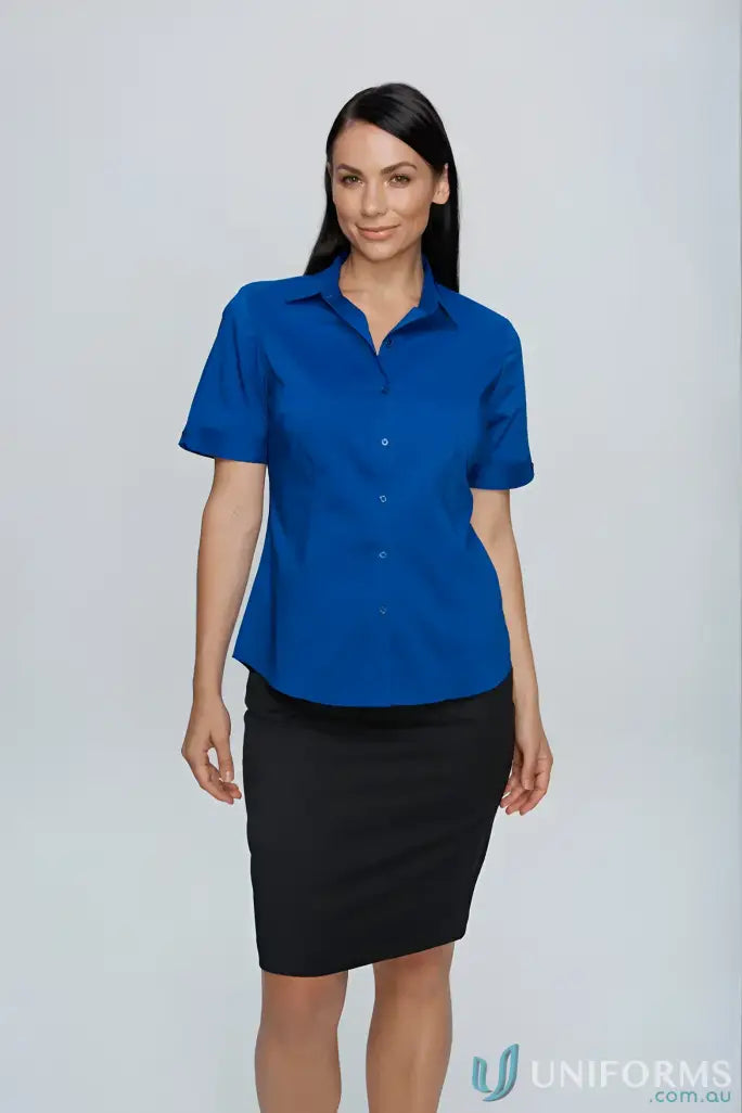 Woman in blue shirt and black skirt wearing Ladies Mosman SS workwear uniform