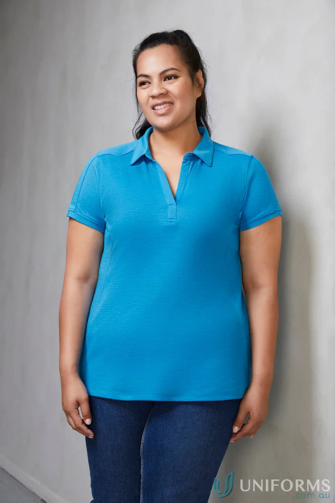 Lady wearing p706ls Ladies Profile Polo feeling fresh in a blue polo shirt