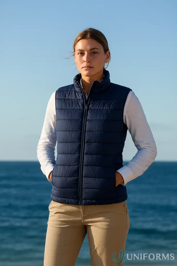 Woman in navy Ladies Puffer Vest with recycled polyester insulation and polyloft® recycled