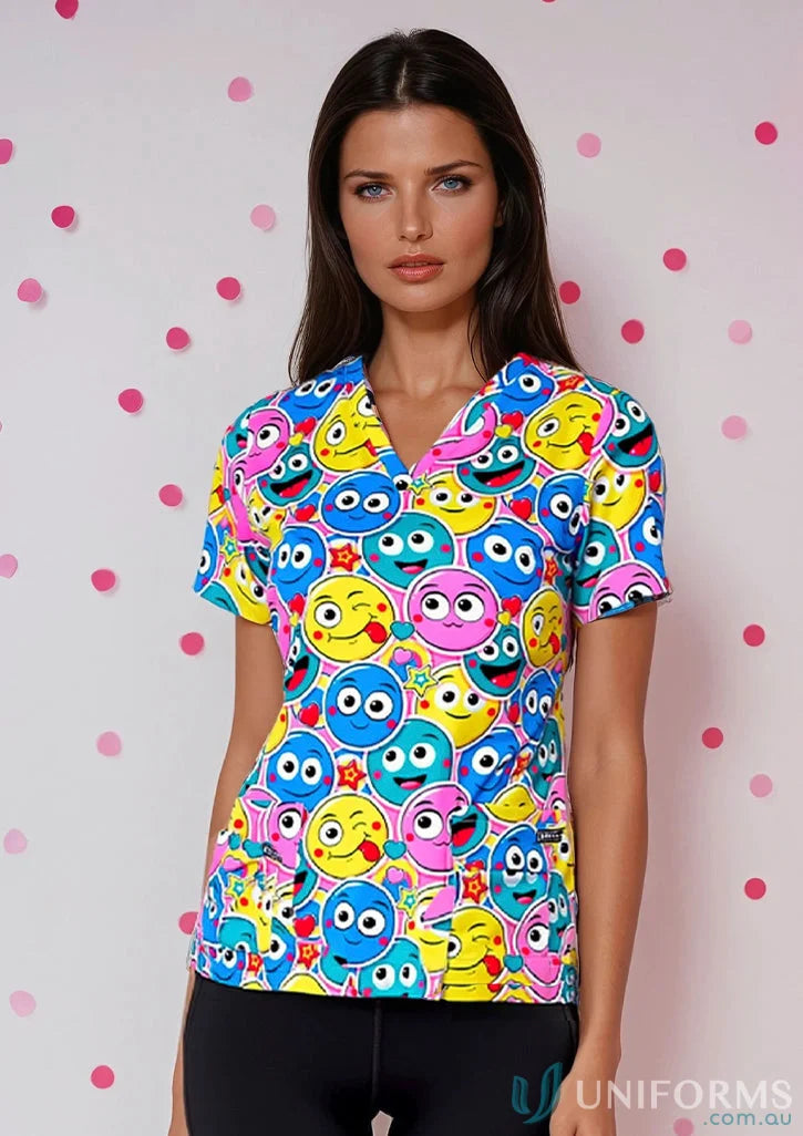 Woman wearing a colorful emoji-patterned 4stp1-smiley scrub top, perfect for beauty therapists uniforms