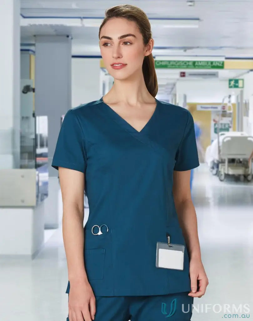 Winning spirit ladies scrub top in teal with pockets, perfect for healthcare professionals