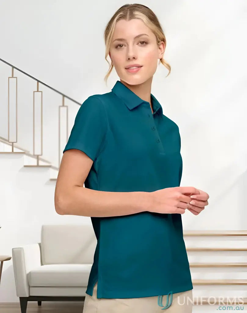 Woman wearing ladies sustainable jacquard knit polo in teal, stylish and eco-friendly