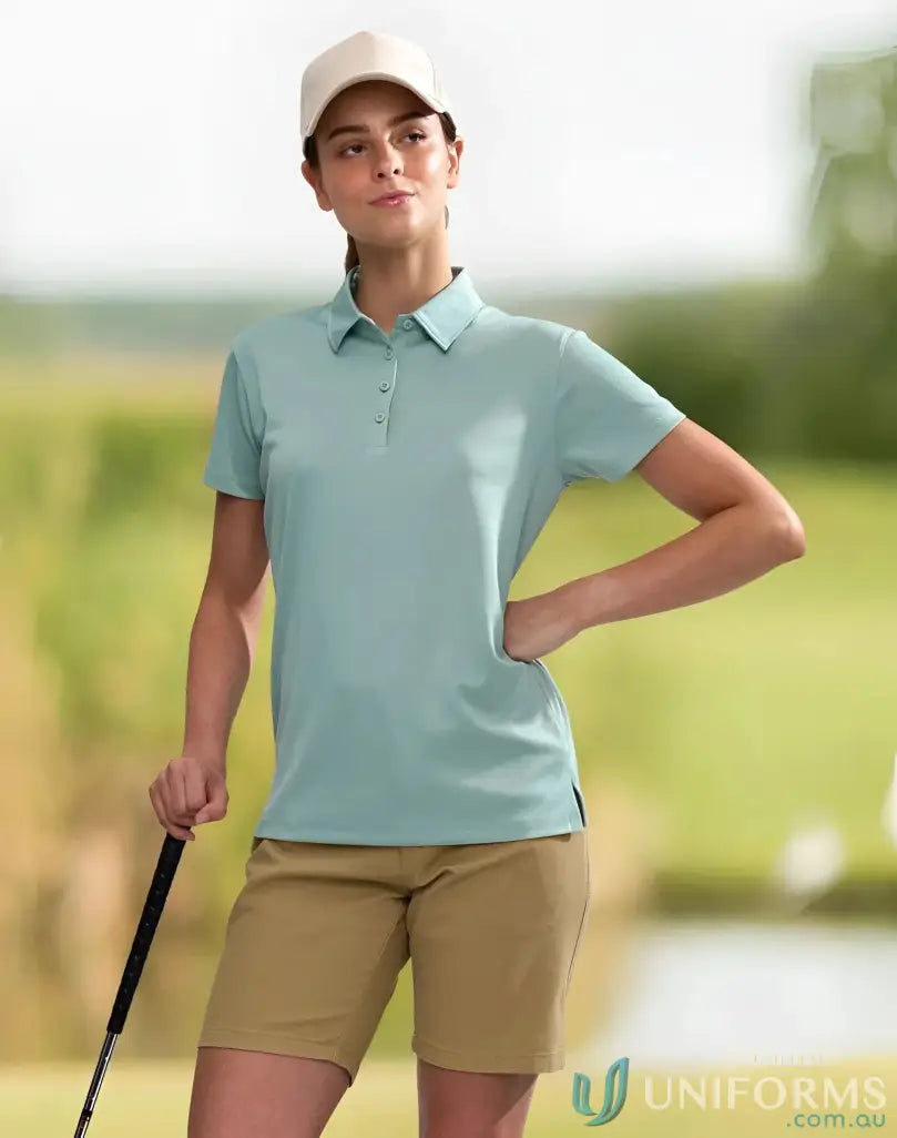 Woman in golf attire wearing Ladies Sustainable Jacquard Knit Polo, eco-friendly style