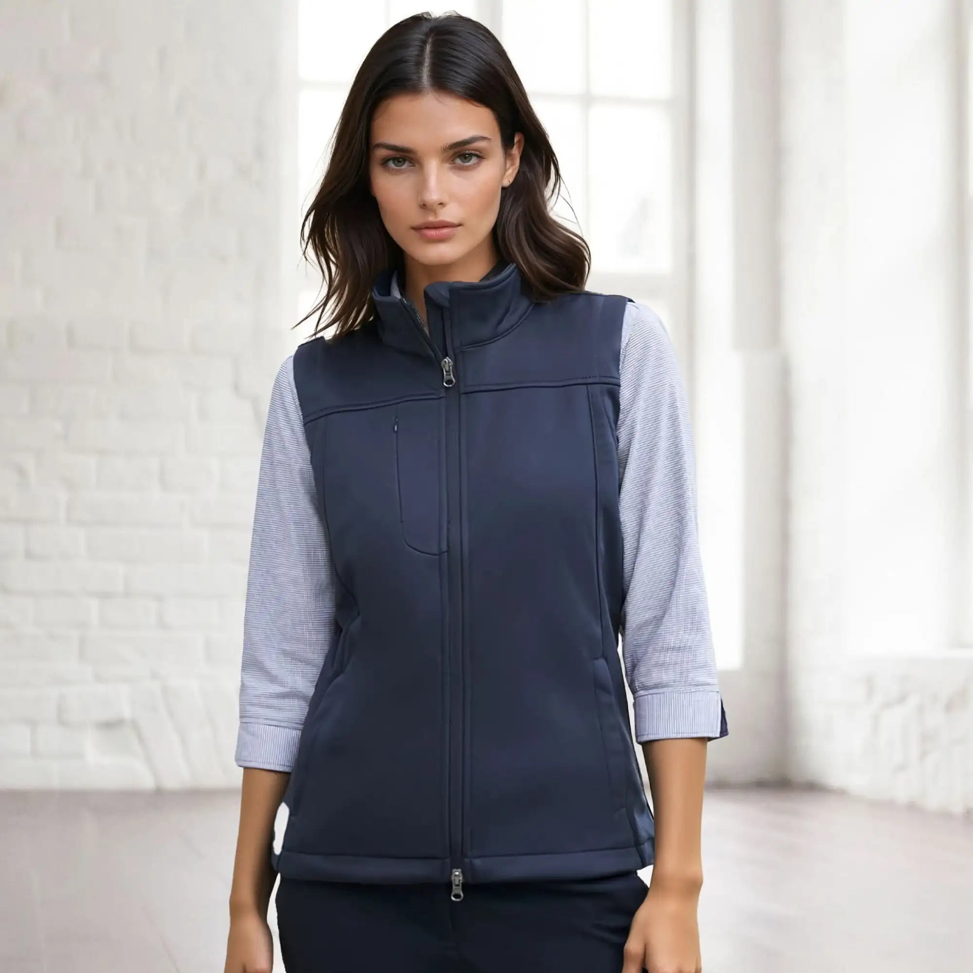 A woman’s navy blue sleeveless vest with a full zipper closure and a stand-up collar.