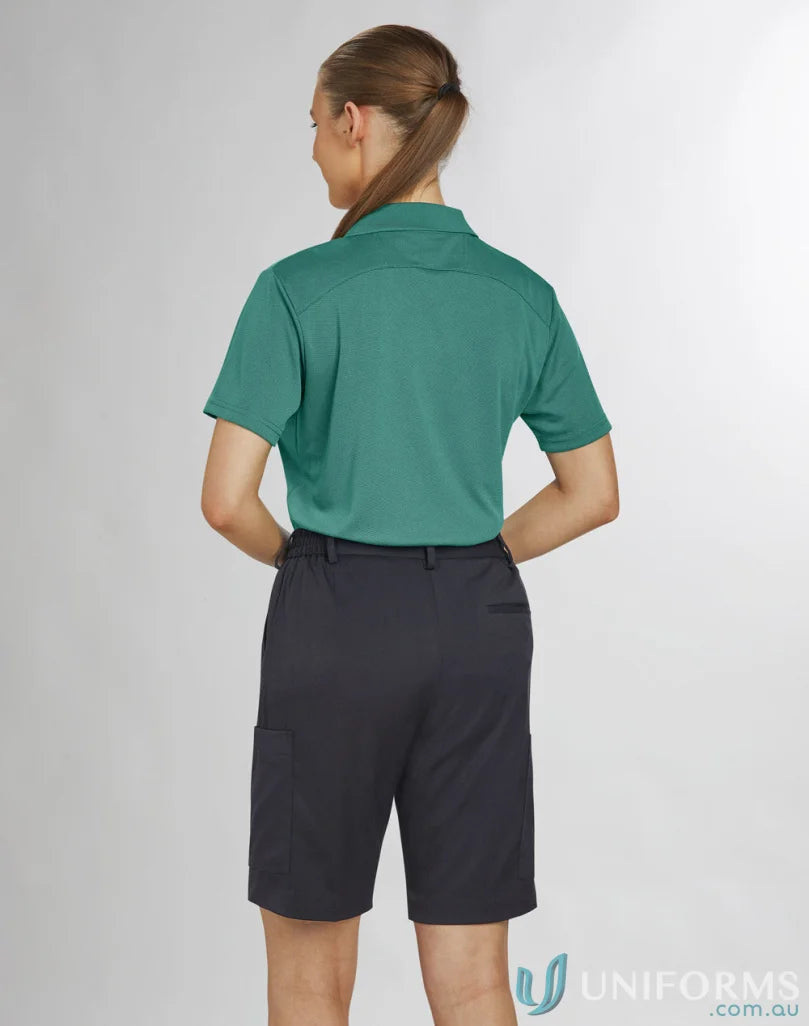 Lady wearing teal polo and dark gray Bermuda shorts from Ladies Utility Cargo collection