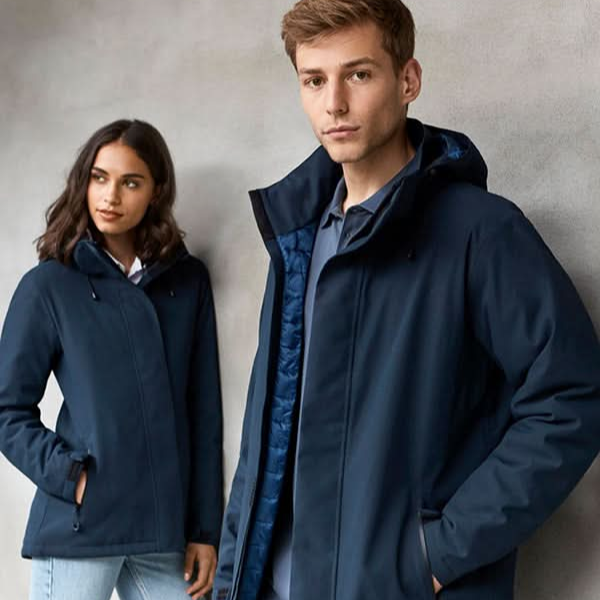 Two people wearing navy blue jackets against a gray background