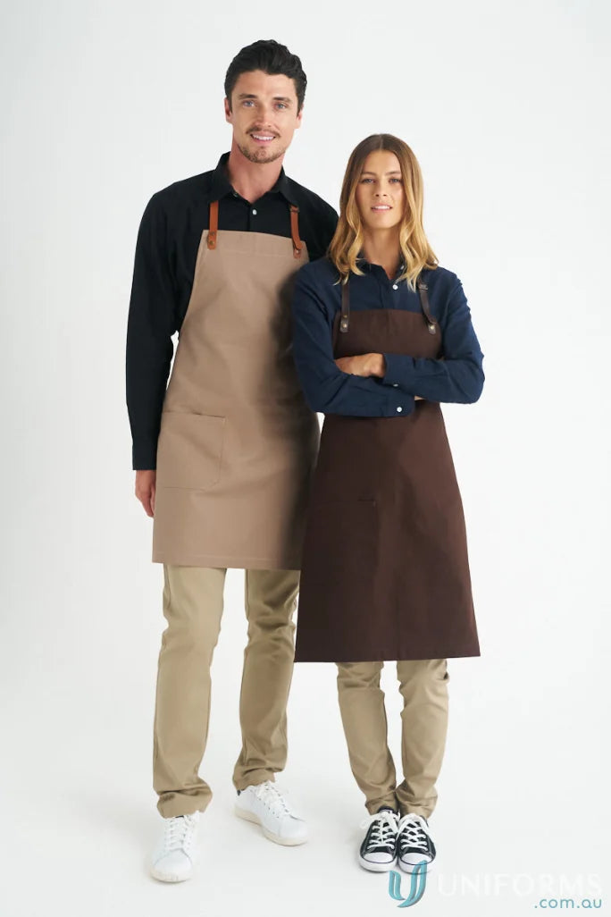 Two people in cotton canvas aprons from Luca for uniforms, available to purchase separately
