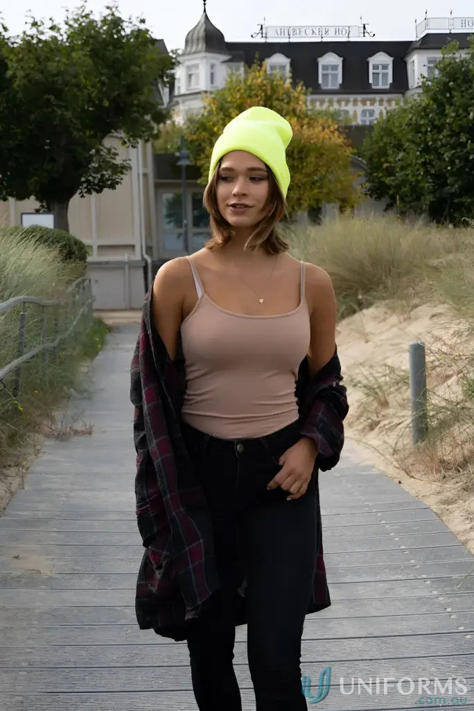 Woman in neon beanie showcasing Luminescent Safety Acrylic Beanie for workwear and uniforms