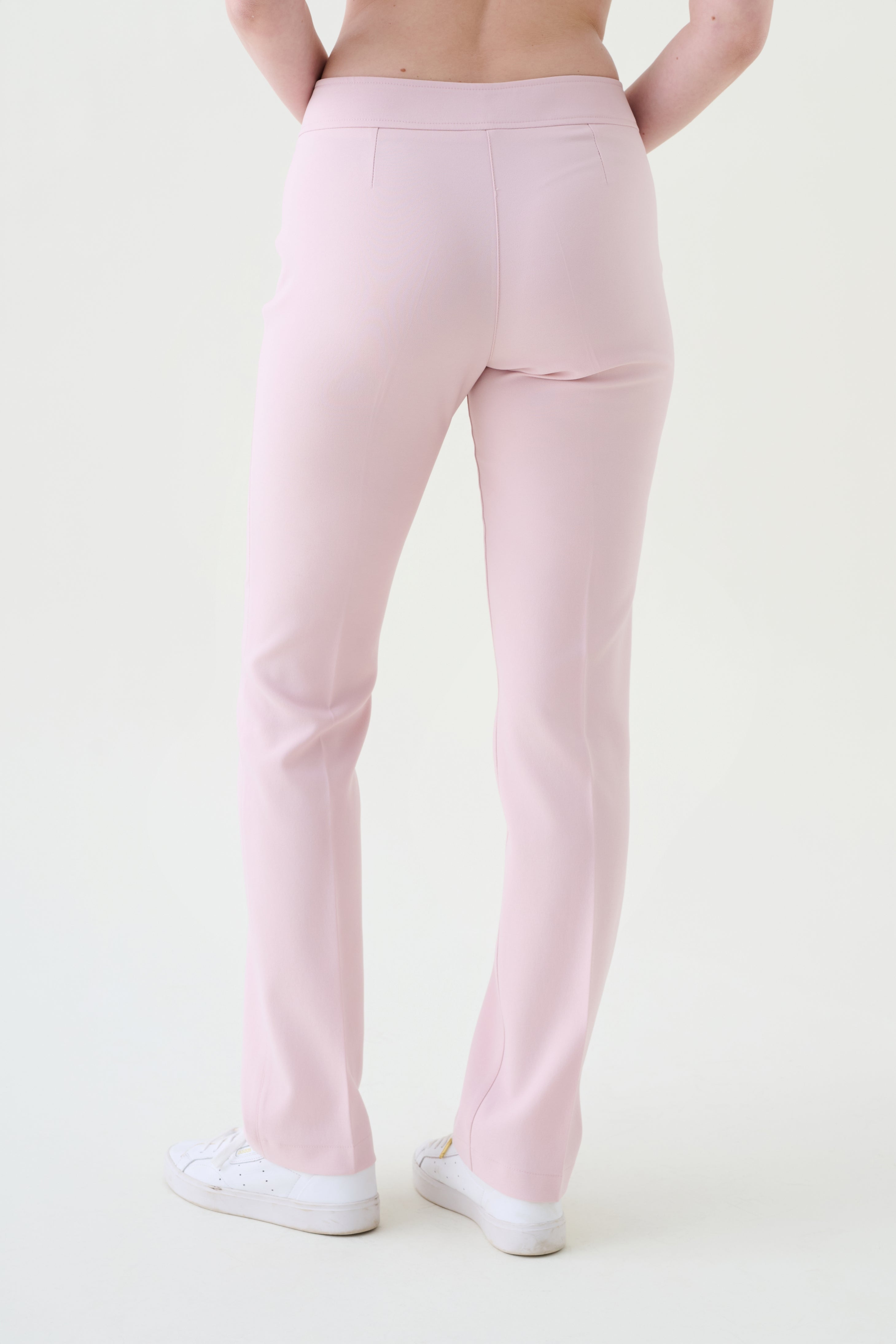 Lunar bi-stretch trousers back view in soft pink with sleek fit and subtle seams