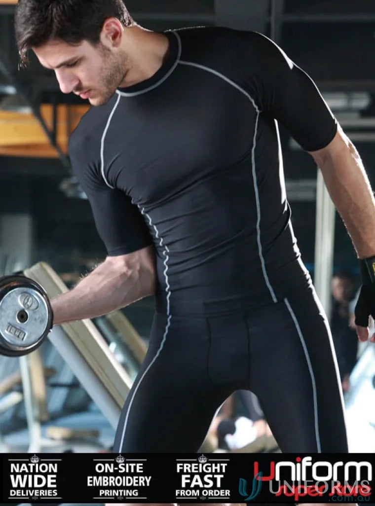 Man in black athletic compression suit lifting weights, perfect for bike shorts or workwear