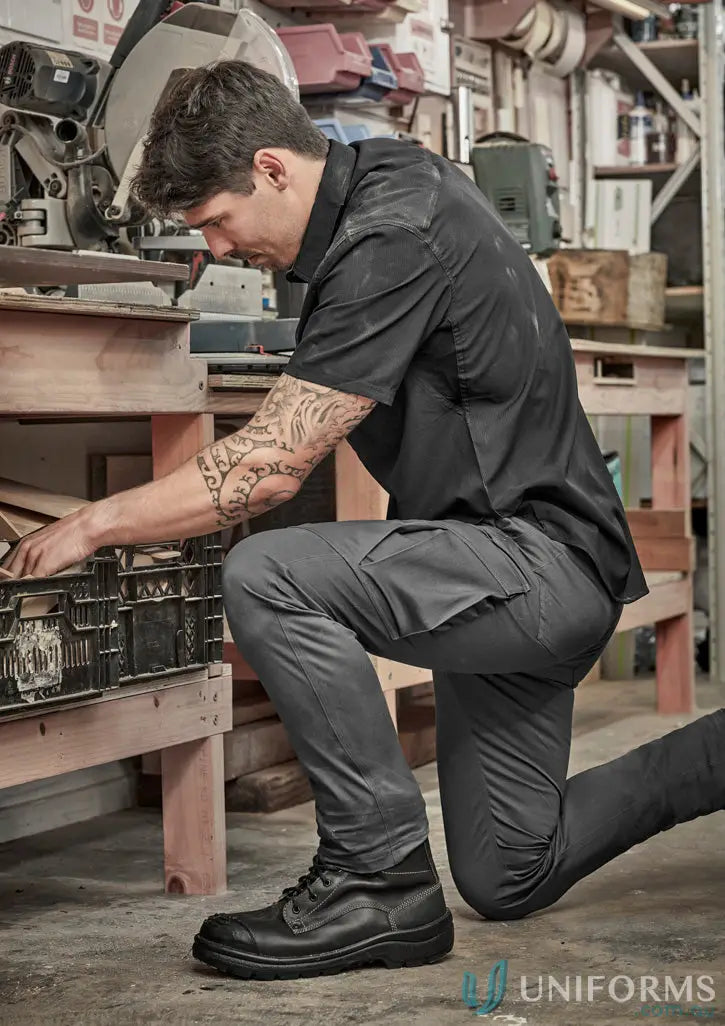 Man in black stretch cargo pants, men’s essential basic workwear style