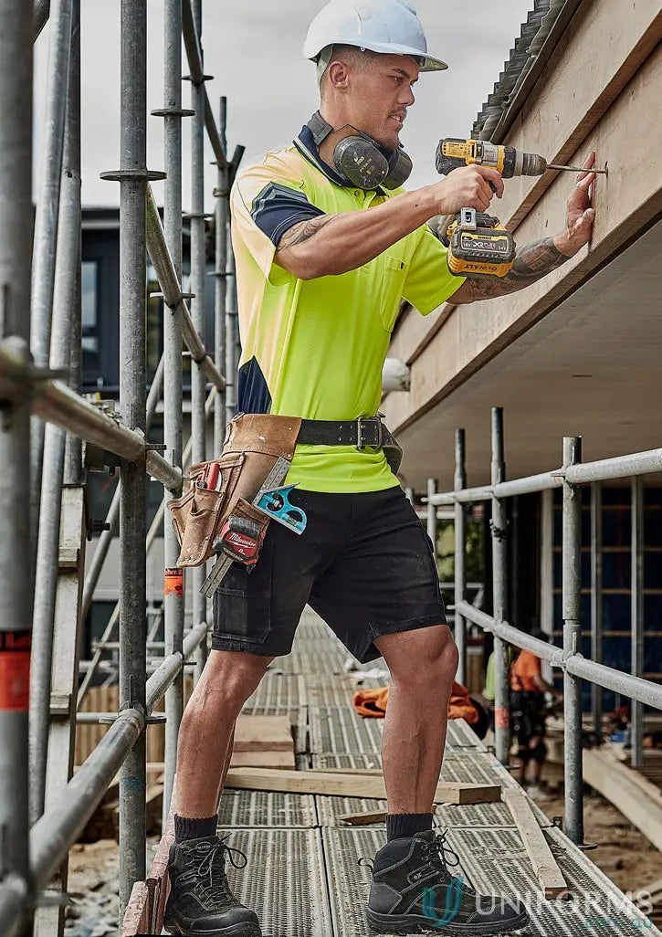 Construction worker using a drill in Mens Essential Stretch Cargo Shorts for tough jobs