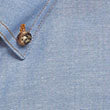 Light blue textured fabric on short sleeve industrial chambray shirt