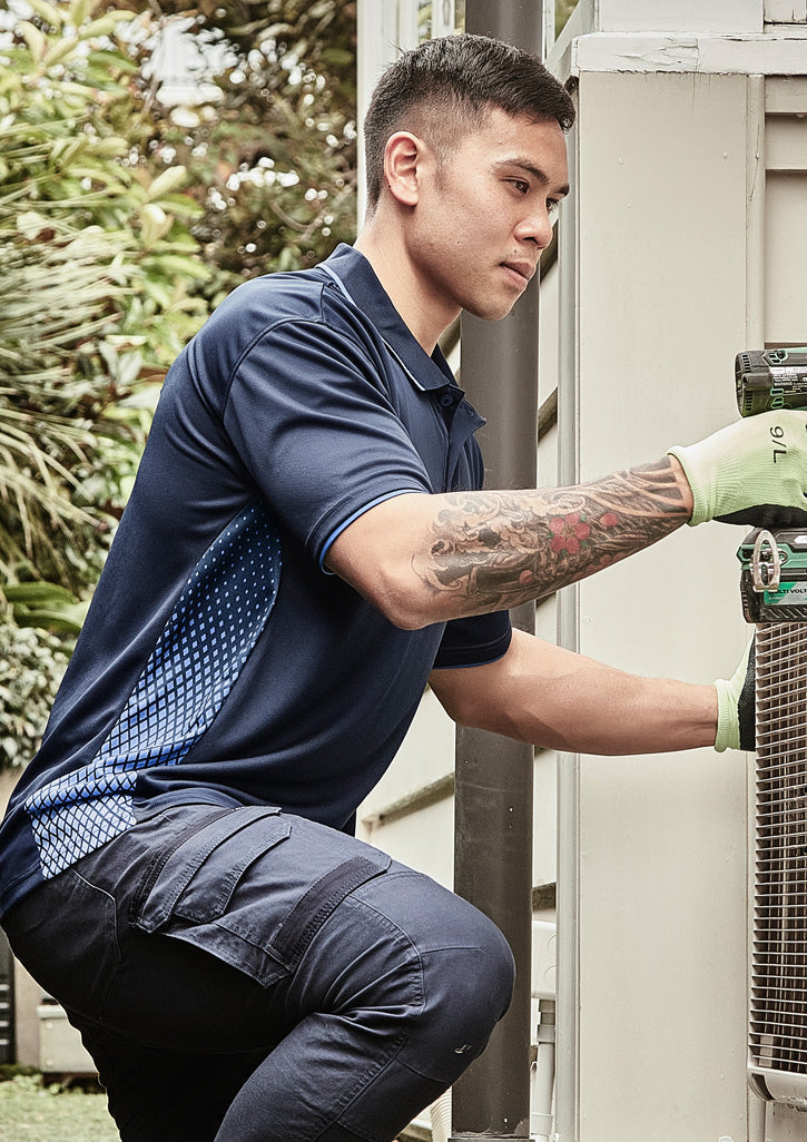 Man in Mens Spark SS Polo with breathable fabric, navy shirt, cargo pants