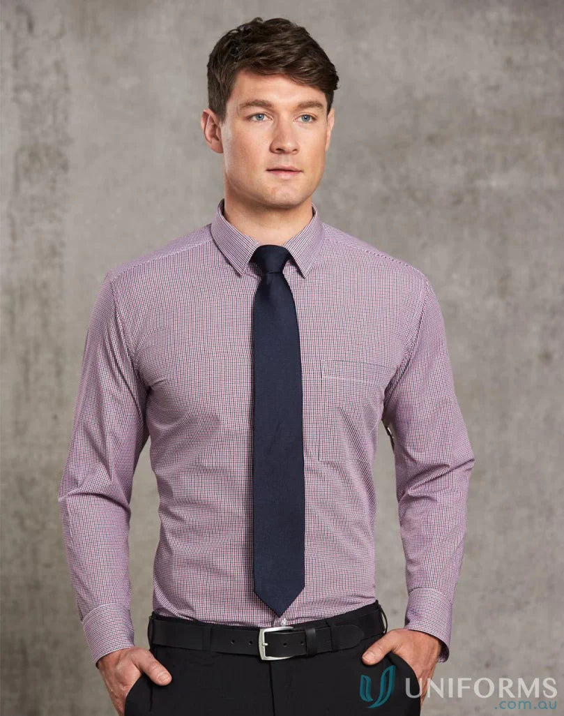 Man wearing mini gingham long tone mini gingham shirt with dark blue tie and black pants
