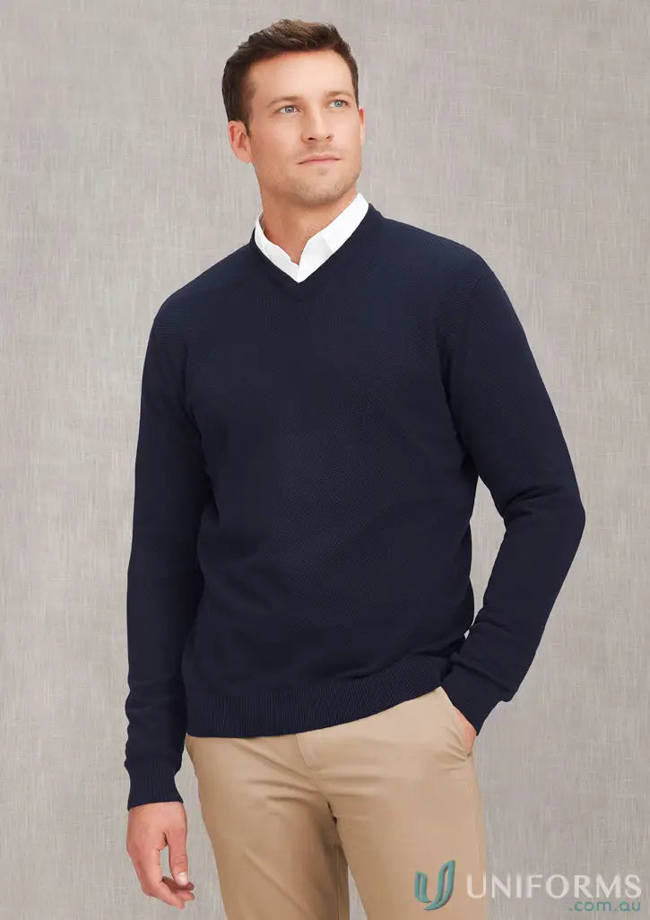 Man wearing men’s Osaka Pineapple Knit Jumper in navy V-neck sweater and khaki pants