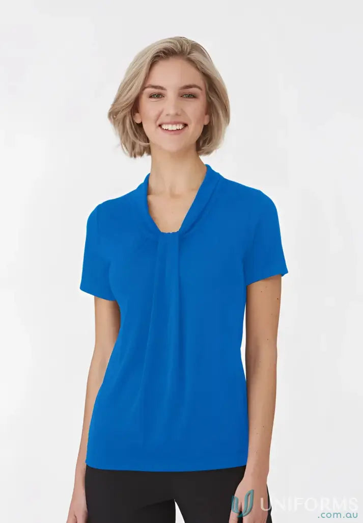 Woman in a blue Pippa Ladies SS Top with soft draped neckline and comfy fit