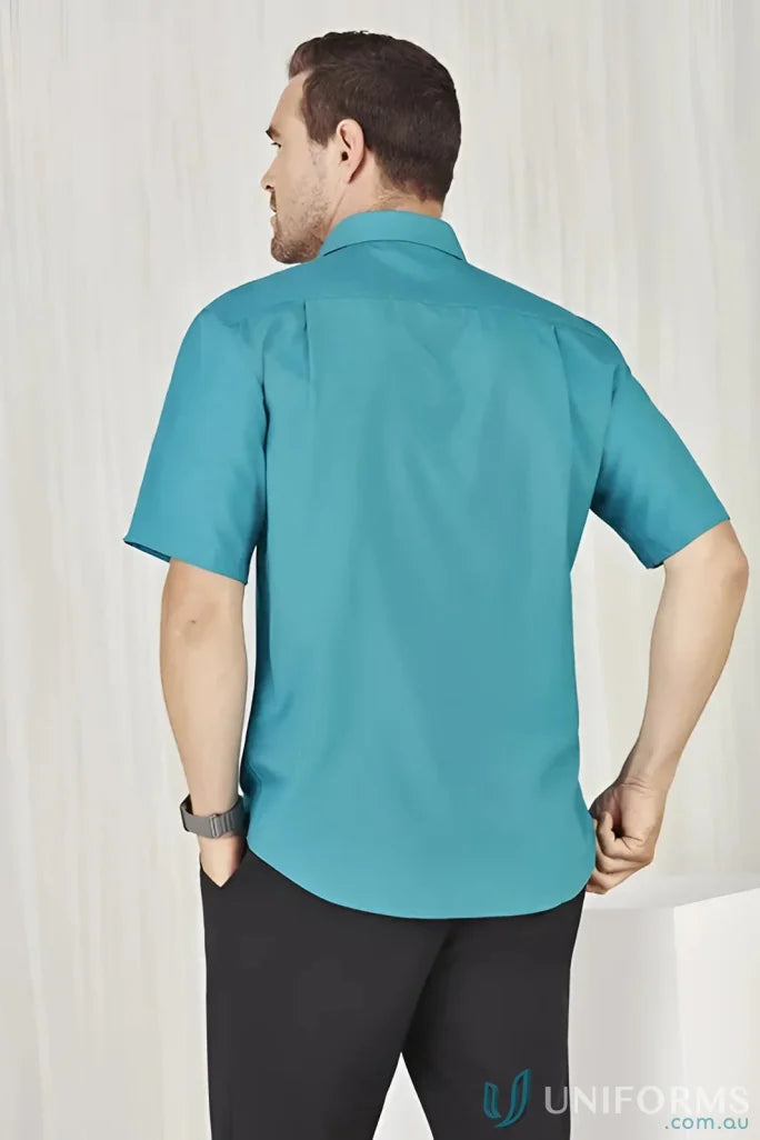 Man wearing teal Men’s Oasis Short Sleeve Shirt showcasing the oasis shirt style