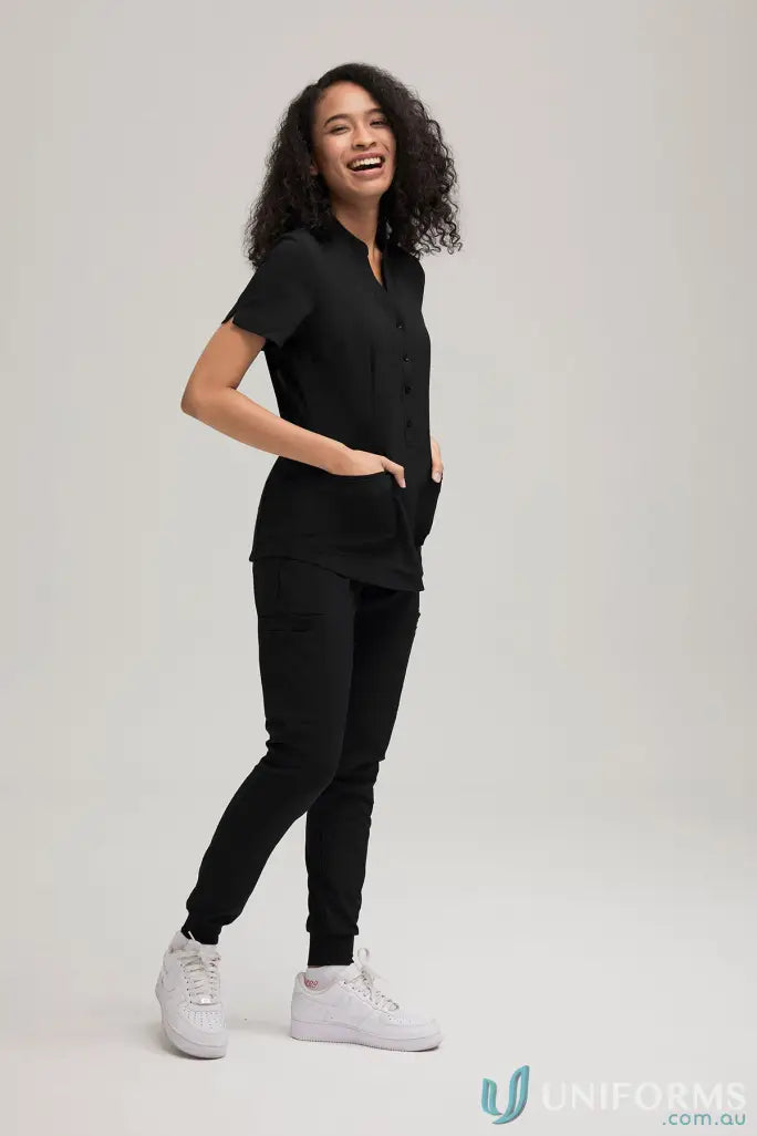 Smiling woman in black Pocket Detail Joggers from City Collection with recycled polyester for all-day comfort