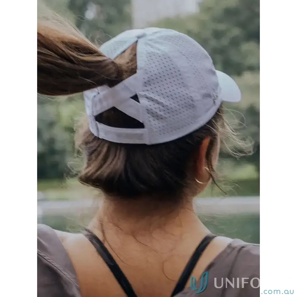 White perforated Ponytail Active Cap with unique ponytail opening and inbuilt cotton sweatband