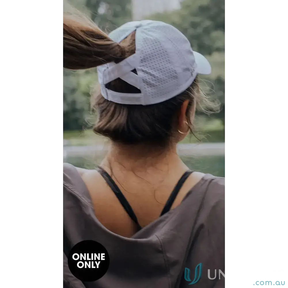Woman wearing Planett Ponytail Cap with unique ponytail opening and inbuilt cotton sweatband