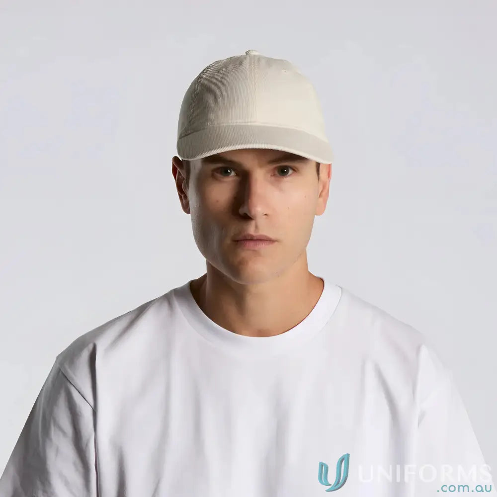 Man wearing a cream cotton 16-wale partridge access cord cap with adjustable fastener