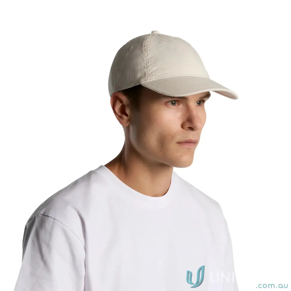 Man wearing a beige access cord cap with adjustable fastener and cotton 16-wale partridge